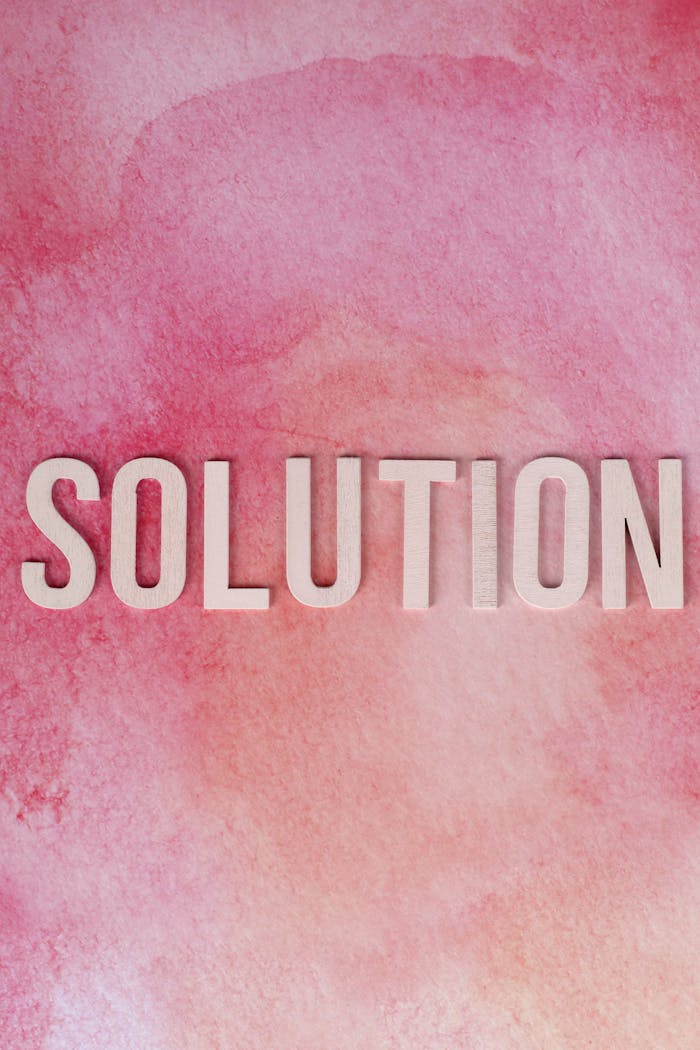 why-choose-us Inspirational 'Solution' text on a vibrant pink watercolor background for motivation and problem-solving concepts.