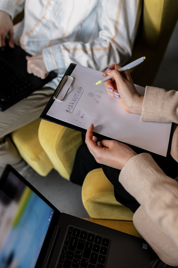 Mastering the First Impression: Your intriguing post title goes here Two professionals in an office working on marketing strategy with laptops and notes.